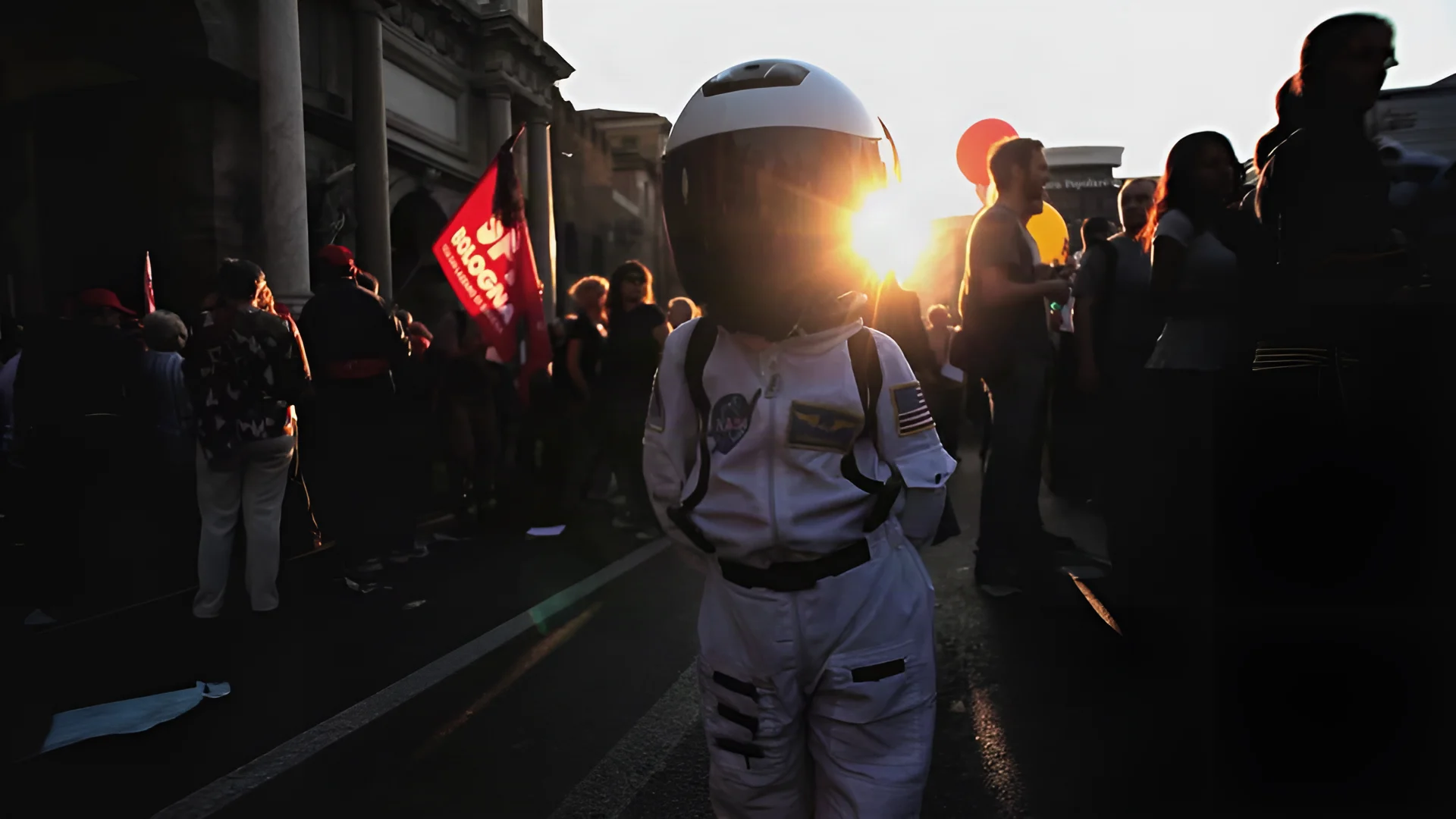 A figure wearing an astronaut suit among passers-by, backlit by the sun, in the Pepsi video.